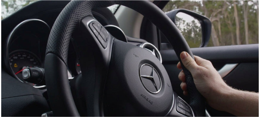 Hands on the Mercedes-Benz X-Class steering wheel during a drive
