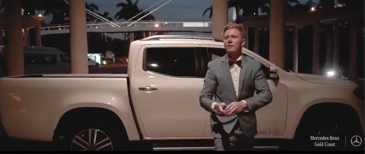 A presenter beside a Mercedes-Benz X-Class at the Gold Coast launch