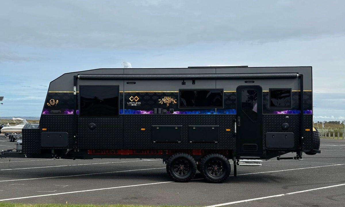 Full exterior side view of the Limitless caravan, photographed away from the Compound