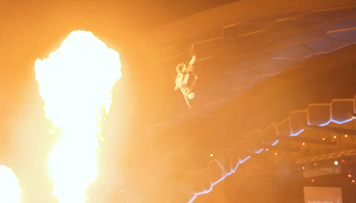 Pat Bowden performing an aerial trick beside flame effects at the X-Class launch