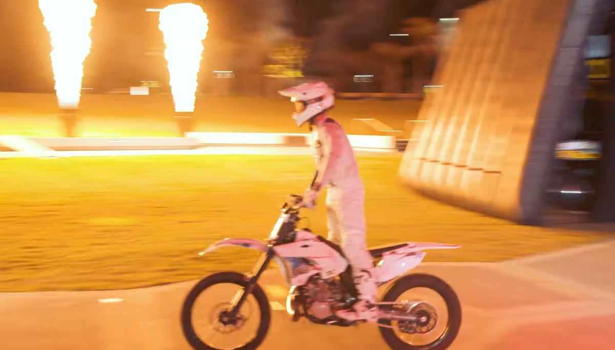 Pat Bowden riding past flame effects at the Mercedes-Benz X-Class launch