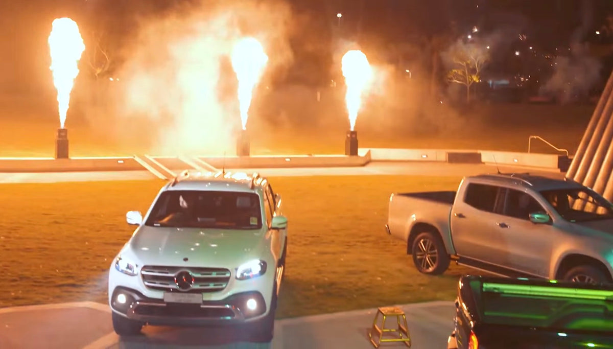 Mercedes-Benz X-Class vehicles revealed with flame effects at the launch.