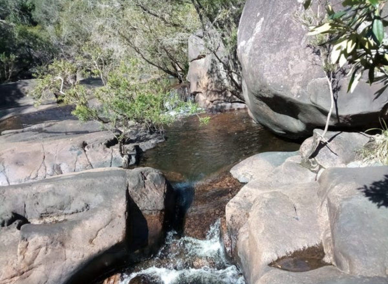 Rock pool and small cascade between large rocks beside the creek at Obsidian Ridge