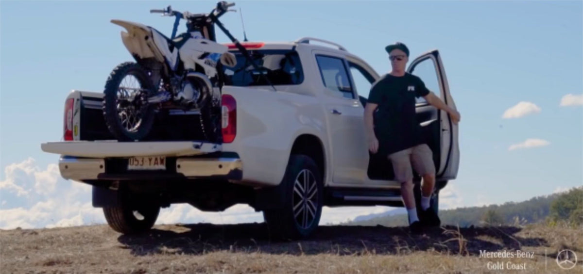 Pat Bowden beside the X-Class with a motocross bike loaded